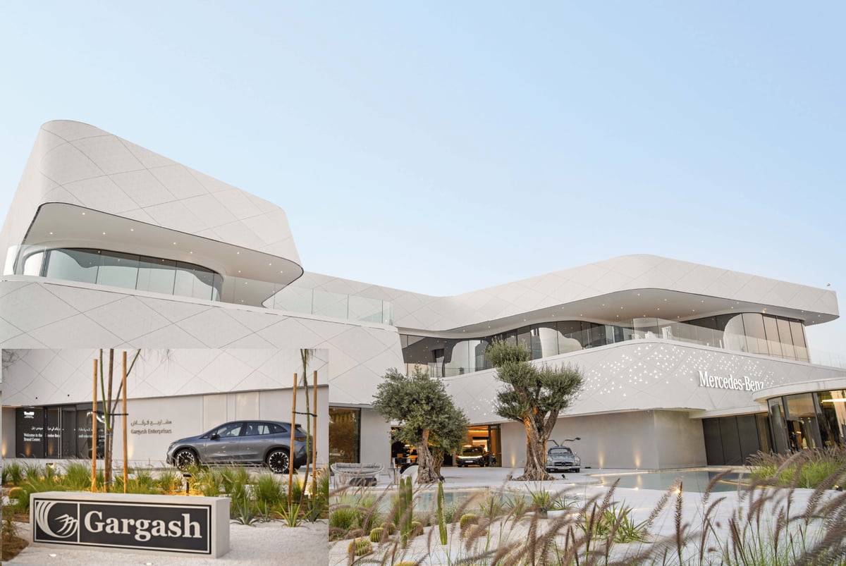The white, sweeping Mercedes-Benz Brand Center by Gargash among olive trees