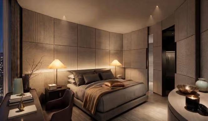 Armani Deluxe Room with a low bed in soft lamplight and panelled walls