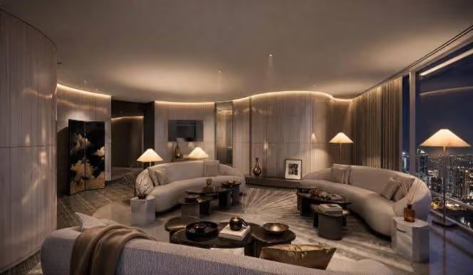 Living room of the Armani Signature Suite, curved sofas and a night view over Downtown Dubai