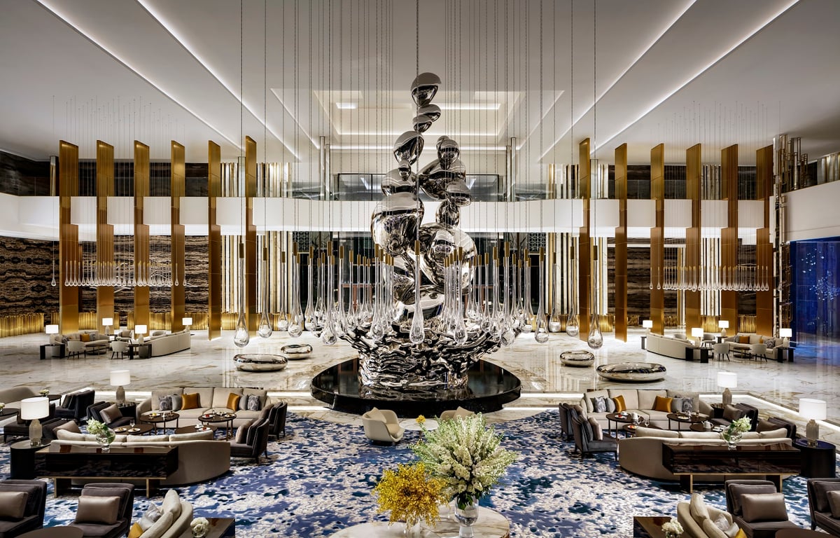 A towering silver droplet sculpture rising from the lobby floor