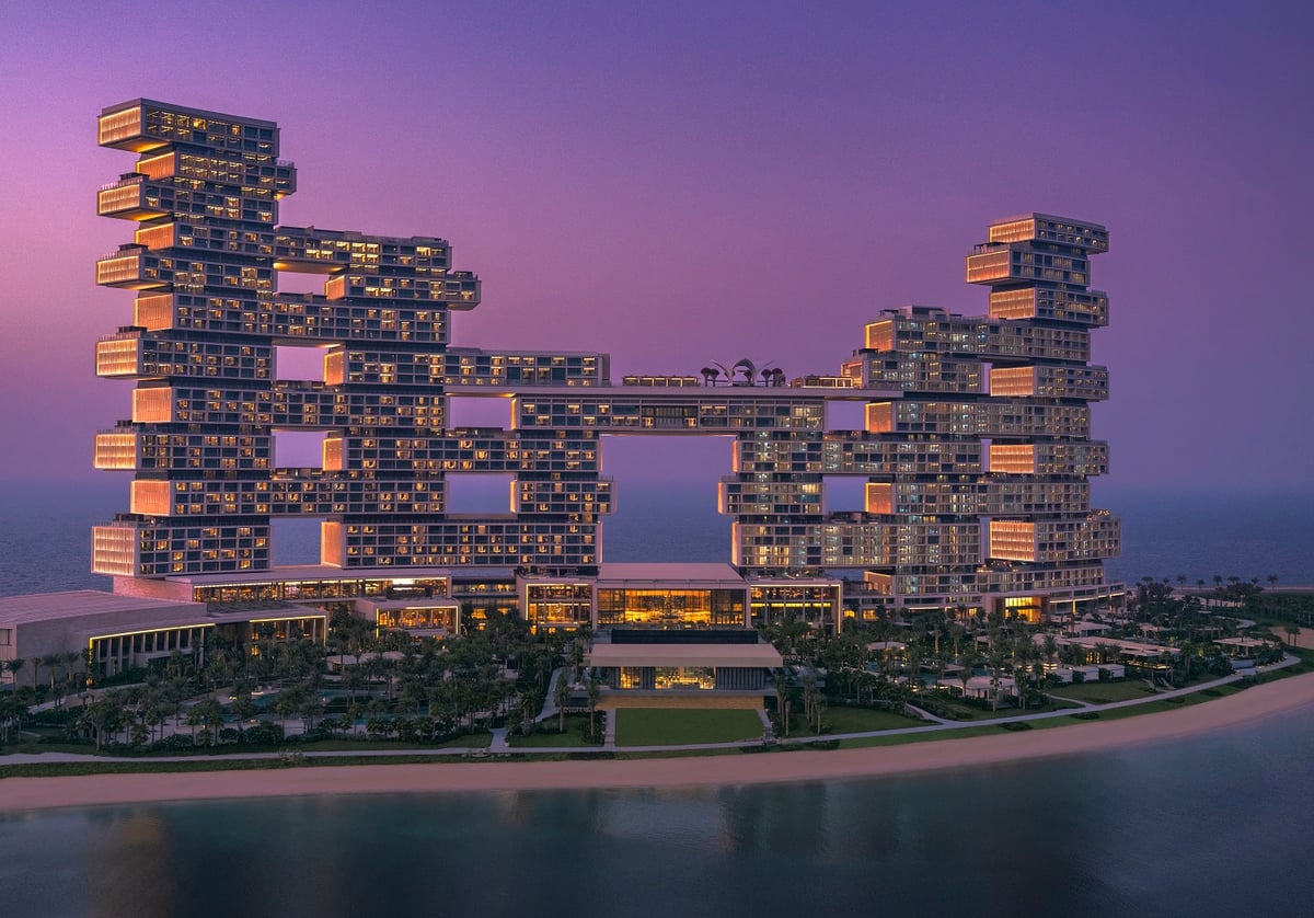 Atlantis The Royal at twilight, its stacked towers lit against a violet sky
