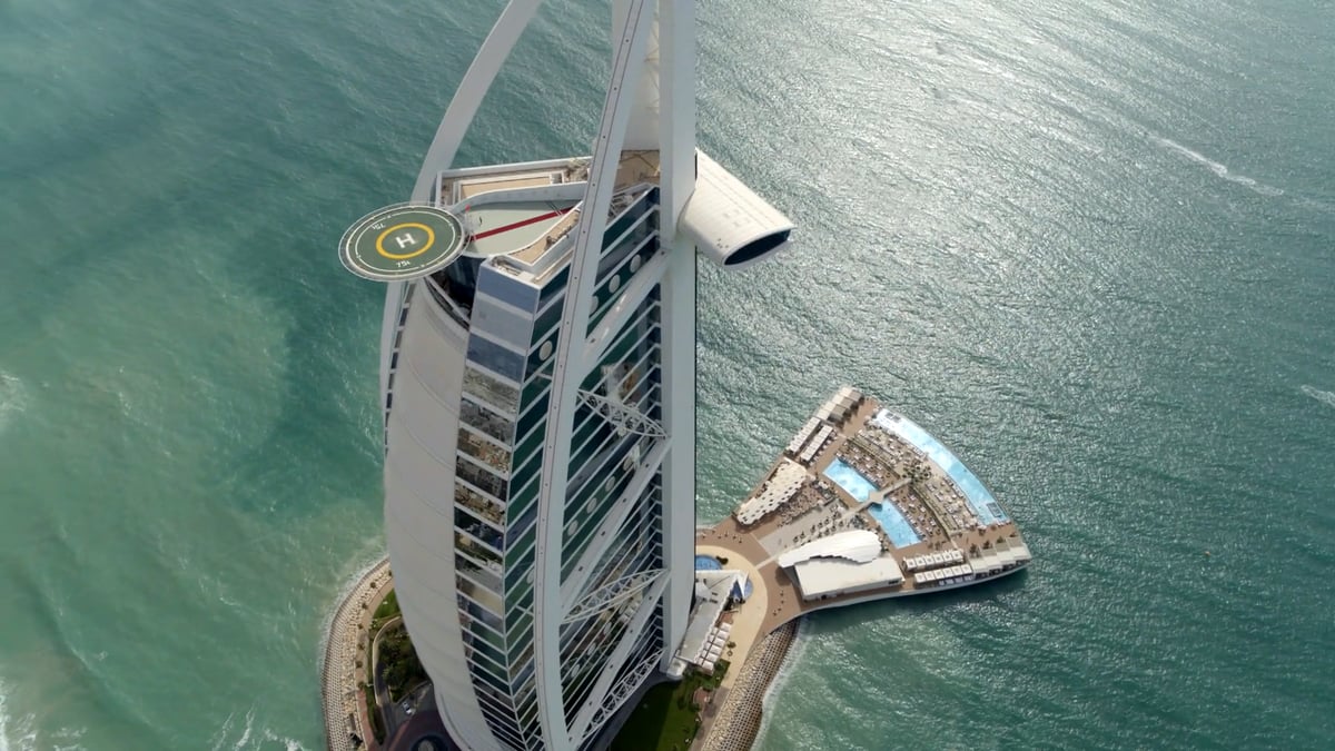 Drone flight around Burj Al Arab: the sail from above, the Terrace pools and the coast towards Madinat Jumeirah