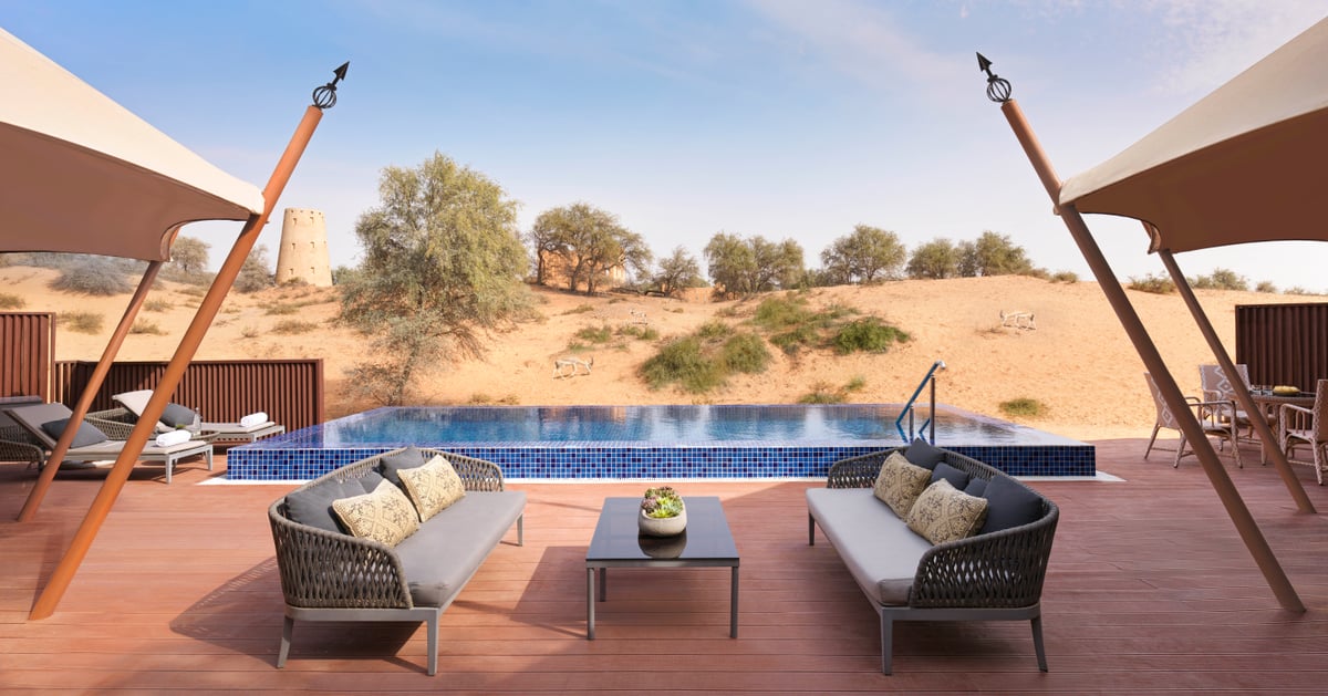 Al Khaimah Villa, deck with outdoor sofas and infinity pool looking over the dunes, at The Ritz-Carlton Al Wadi Desert.
