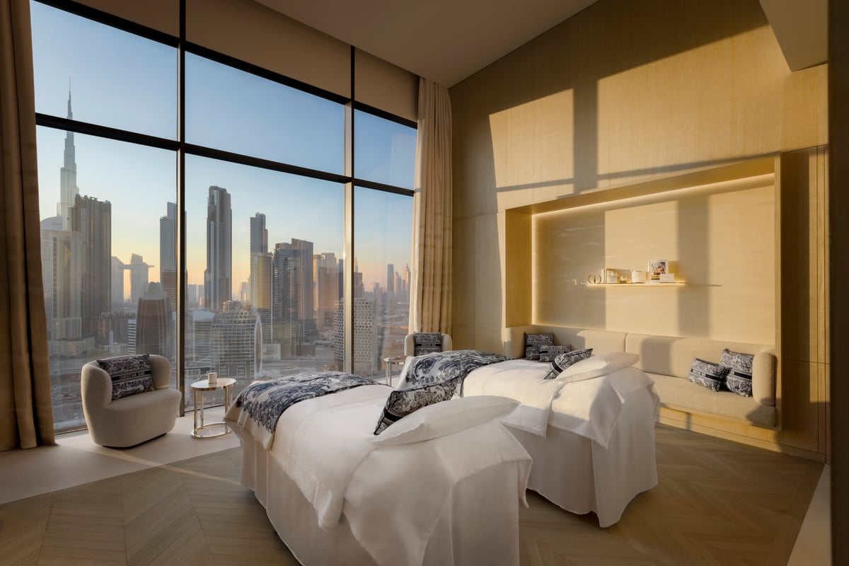 Couples treatment room at Dior Spa The Lana with two beds and windows facing the skyline.