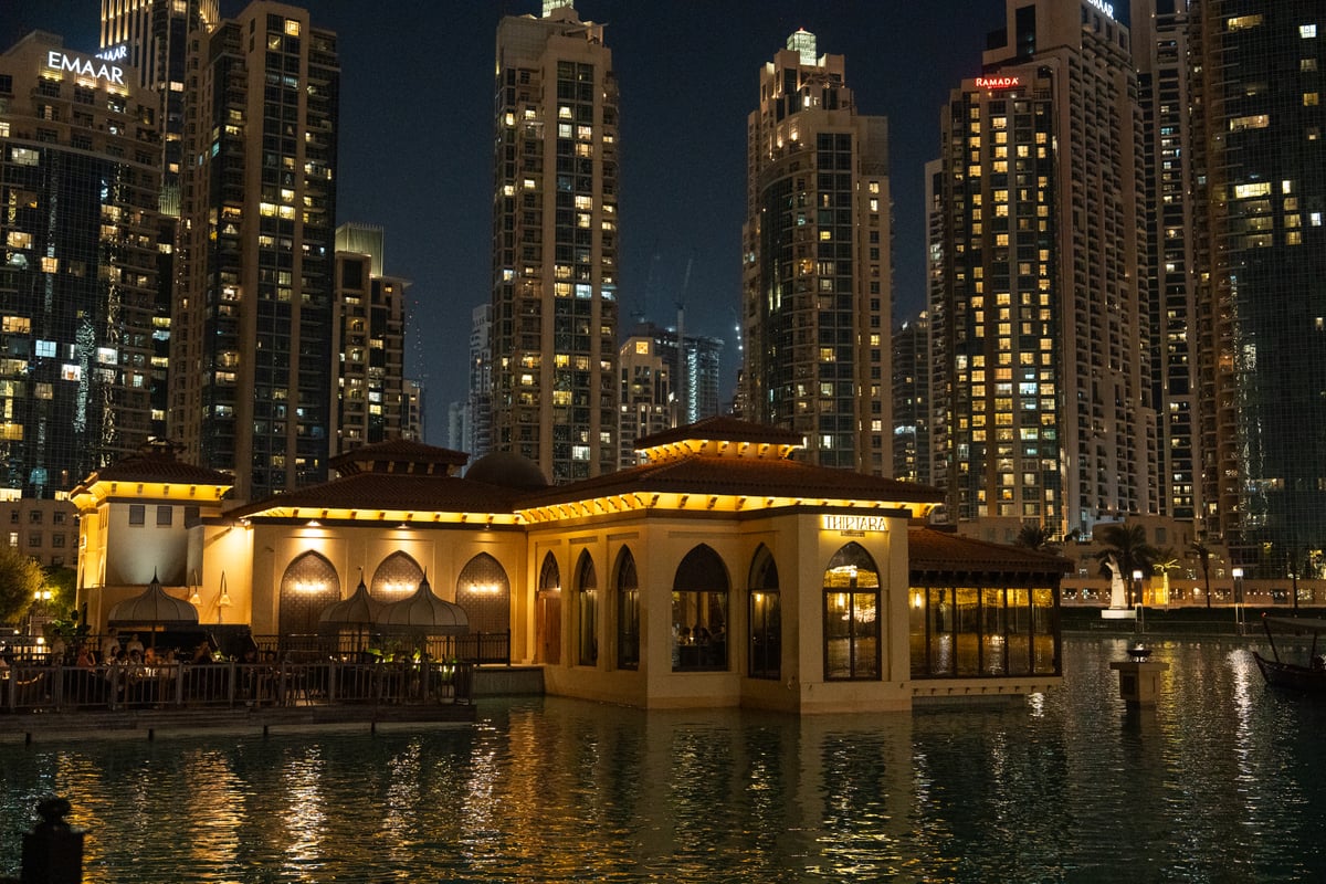 Thiptara's pavilion lit gold on the Burj Lake, the Downtown towers behind
